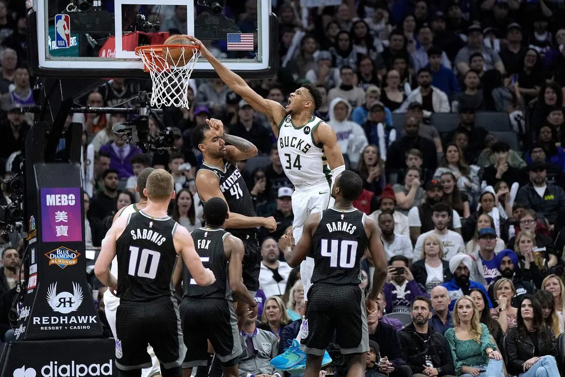 Giannis Antetokounmpo of the Milwaukee Bucks dunks over Trey Lyles of the Sacramento Kings during the fourth quarter at Golden 1 Centre.