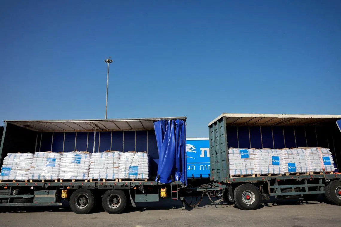 FILE PHOTO: Trucks carrying aid line up at the Kerem Shalom crossing between Israel and Gaza, before going into Gaza, on the Israeli side of the Israel-Gaza border, May 22, 2025. REUTERS/Ammar Awad/File Photo