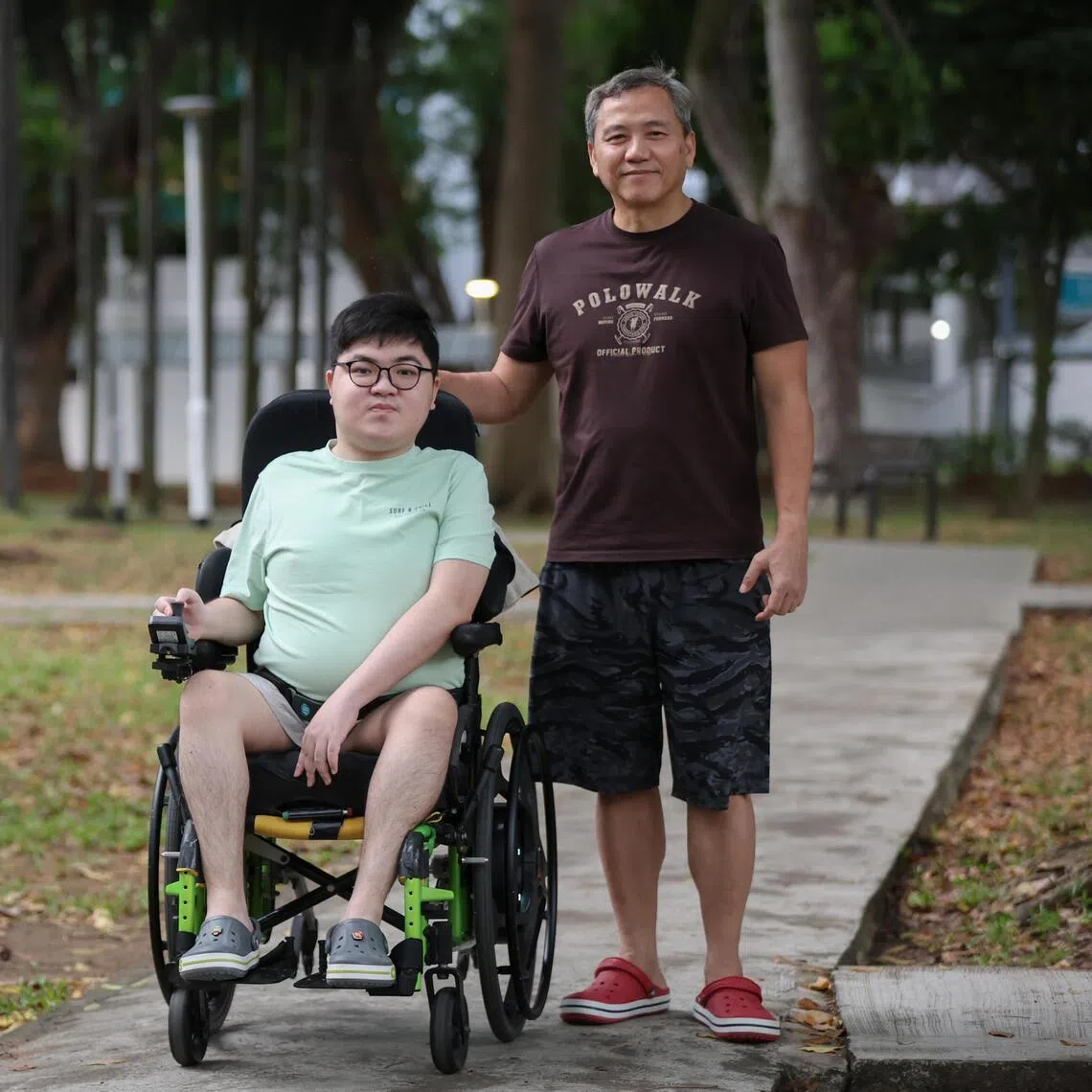 Aaron Sim (left) credits his father Michael for supporting him through his journey with muscular dystrophy and Asperger's Syndrome. 