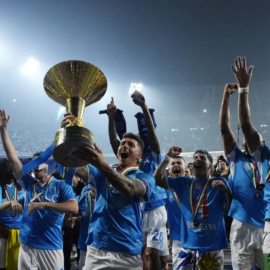 Soccer Football - Serie A - Napoli v Cagliari - Stadio Diego Armando Maradona, Naples, Italy - May 24, 2025 Napoli's ] Giovanni Di Lorenzo celebrates with the trophy and teammates after winning Serie A REUTERS/Matteo Ciambelli