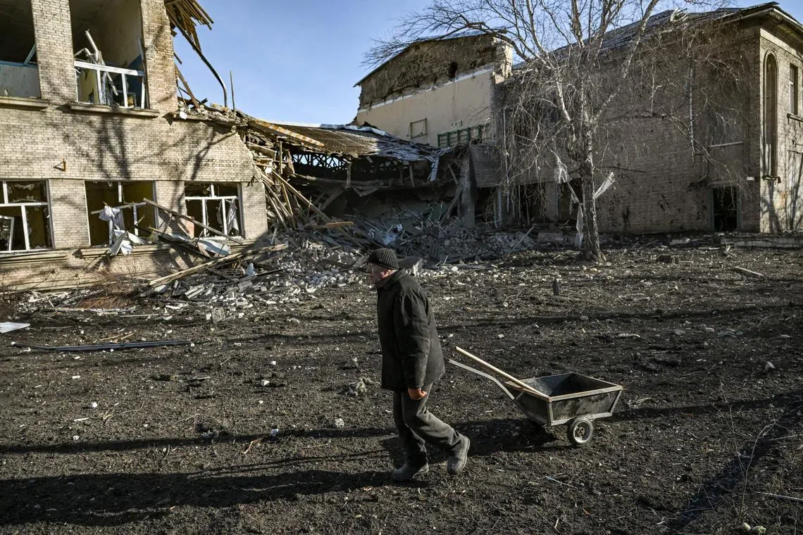 A man walks outside a destroyed school after a missile strike in Kramatorsk, Dombass regions, on March 6, 2023, amid Russian invasion of Ukraine. (Photo by Aris Messinis / AFP)