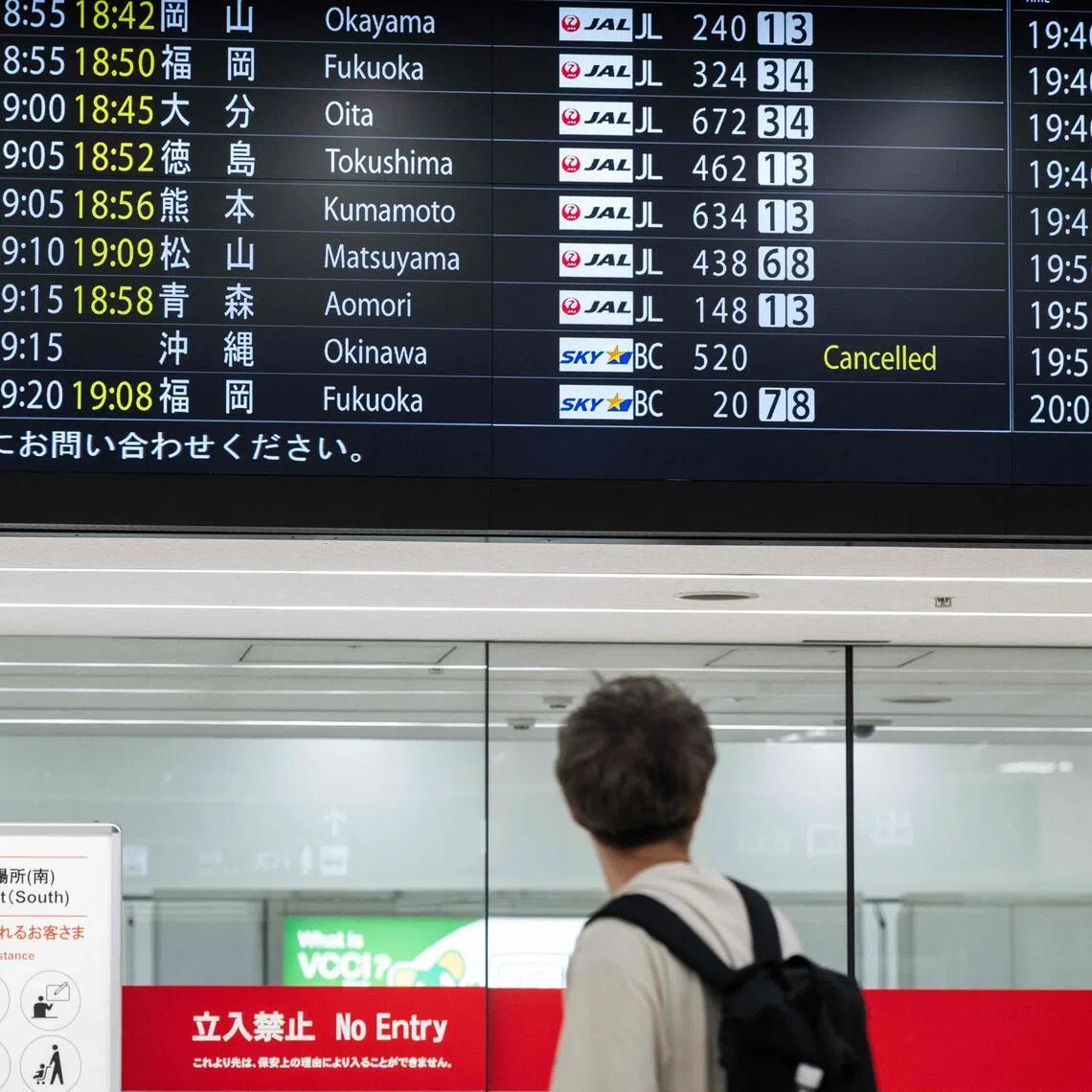 A flight departures board showing a cancelled flight to Okinawa, at Haneda Airport on June 1. More than 320 flights have been cancelled because of Typhoon Jangmi.