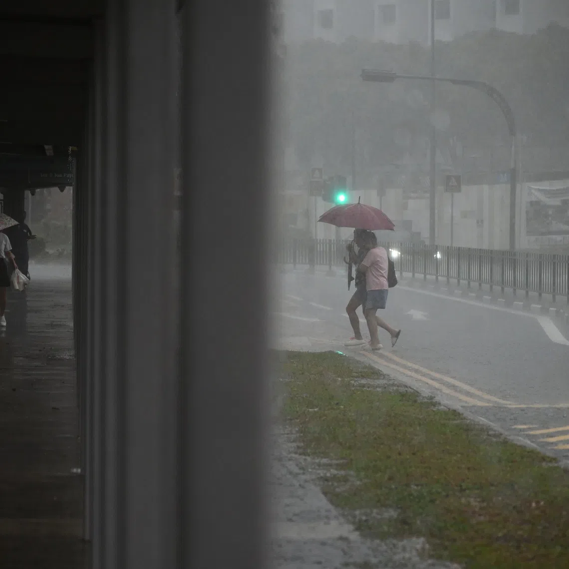 People caught in the heavy downpour in Toa Payoh Lorong 8 at 8am on Oct 15.