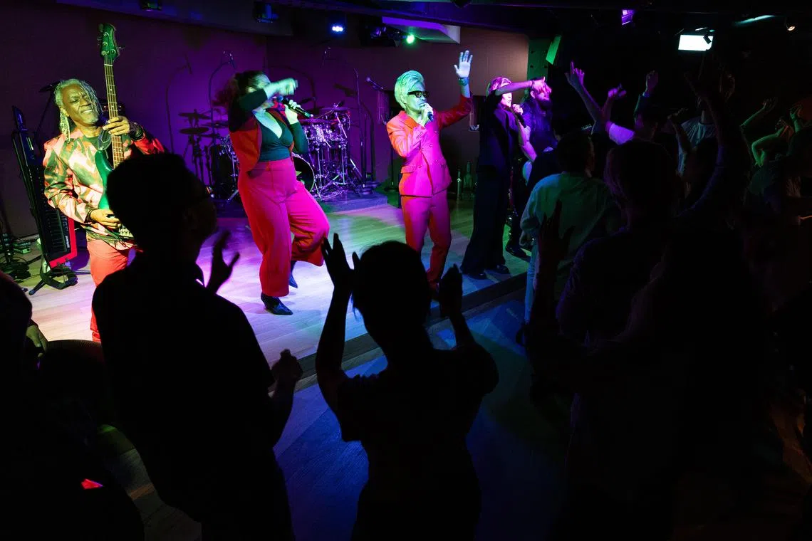 Patrons dancing to the Gravity Band's performance at BRIX in Grand Hyatt Singapore. 