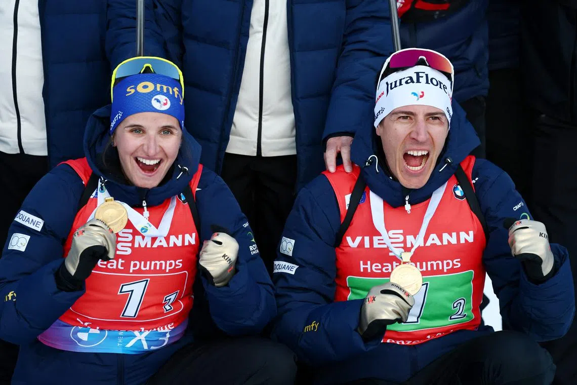 Winter Sports - Biathlon World Championships - Lenzerheide, Switzerland - February 20, 2025 France's Quentin Fillon Maillet and Julia Simon pose with medals after winning the Single Mixed Relay REUTERS/Denis Balibouse
