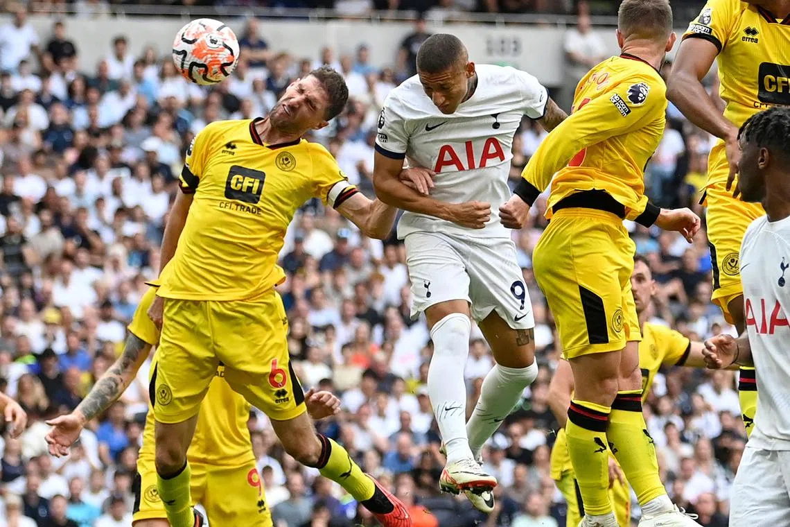 Tottenham Hotspur's Brazilian striker Richarlison (centre) heads home their first goal.