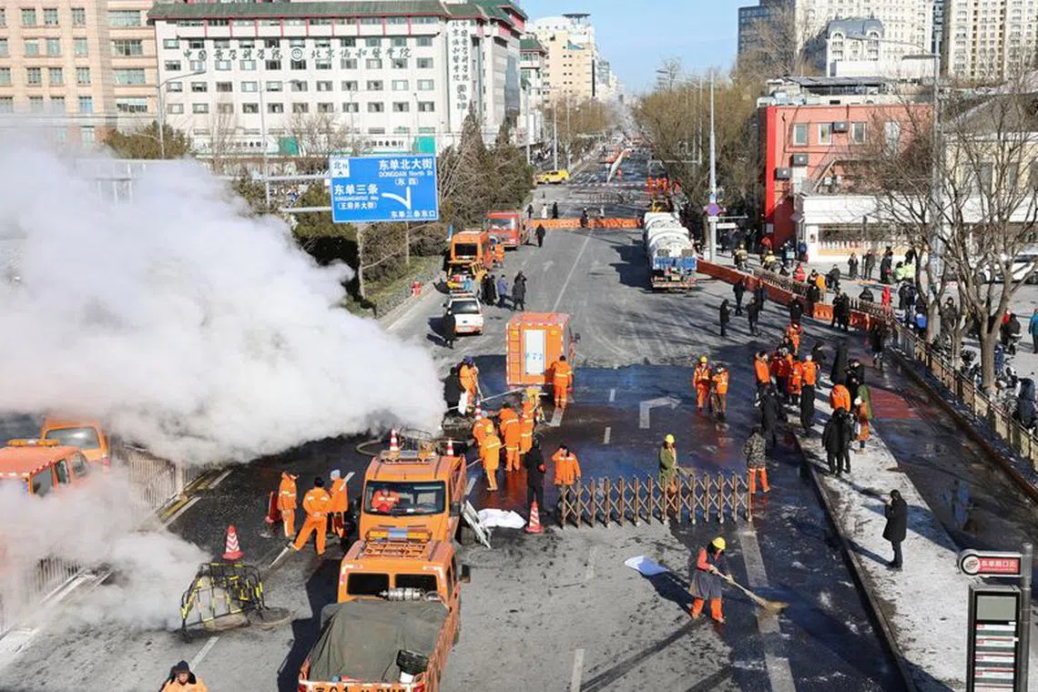 Workers conduct repair work at the site where a thermal pipeline that supplies heating leaked, during winter solstice in Beijing, China December 22, 2023. REUTERS/Florence Lo