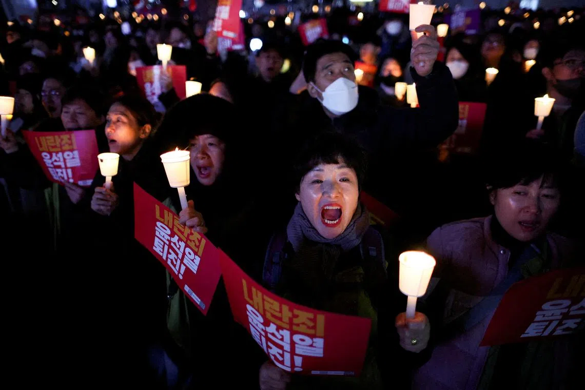 People attend a candlelight vigil condemning South Korean President Yoon Suk Yeol's surprise declaration of martial law last night, which was reversed hours later, and to call for his resignation, in Seoul, South Korea, December 4, 2024. REUTERS/Kim Hong-Ji