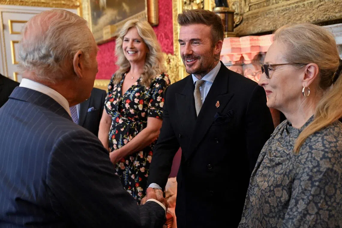 David Beckham shakes hands with King Charles III during the King's Foundation Awards ceremony.