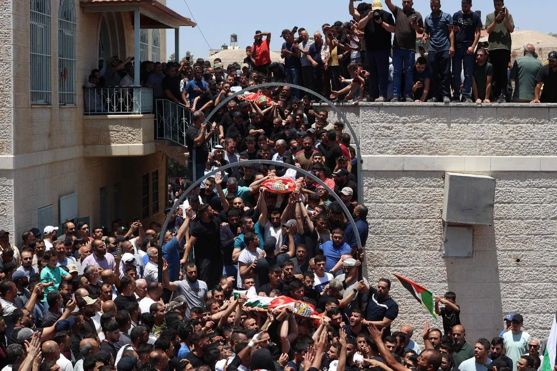 Palestinian mourners attending the funeral of three people killed the previous day in Kafr Malik in the Israeli occupied West Bank, on June 26, 2025.