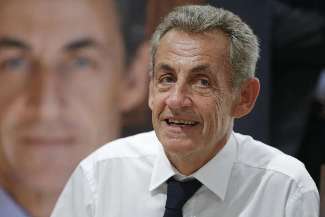 Former French President Nicolas Sarkozy looks on as he signs his new book "Le Temps des Combats" (The Time of Battles) at the Baleone Commercial Centre in Sarrola-Carcopino, near Ajaccio, on the French Mediterranean island of Corsica, on August 26, 2023. (Photo by Pascal POCHARD-CASABIANCA / AFP)