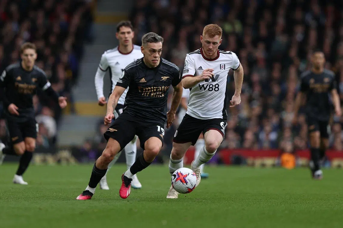 Fulham's English midfielder Harrison Reed vying with Arsenal's Belgian midfielder Leandro Trossard during the English Premier League football match between Fulham and Arsenal at Craven Cottage. The Gunners won 3-0 with Trossard laying on all of the goals.