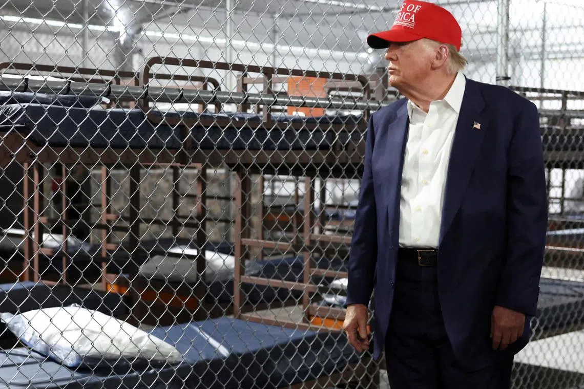 FILE PHOTO: U.S. President Donald Trump visits a temporary migrant detention center informally known as \"Alligator Alcatraz\" in Ochopee, Florida, U.S., July 1, 2025. REUTERS/Evelyn Hockstein/File Photo
