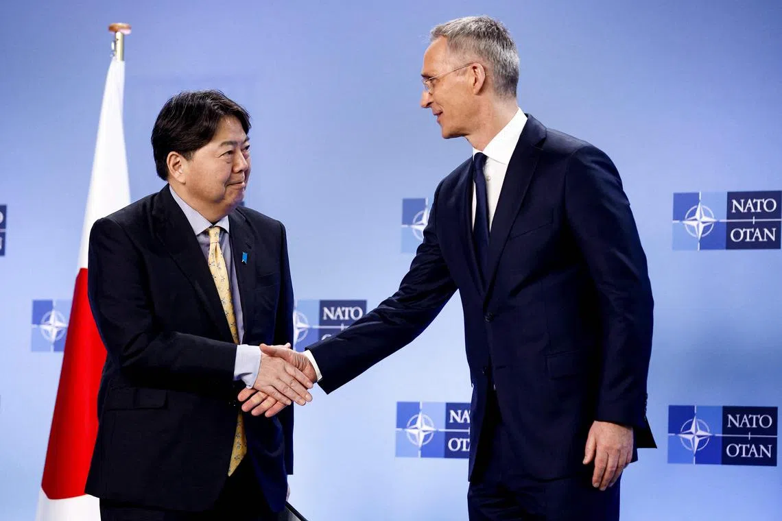 Japan's Foreign Minister Yoshimasa Hayashi (L) and NATO Secretary General Jens Stoltenberg give a press conference during a NATO Foreign ministers meeting in Brussels on April 4, 2023. (Photo by Kenzo TRIBOUILLARD / AFP)