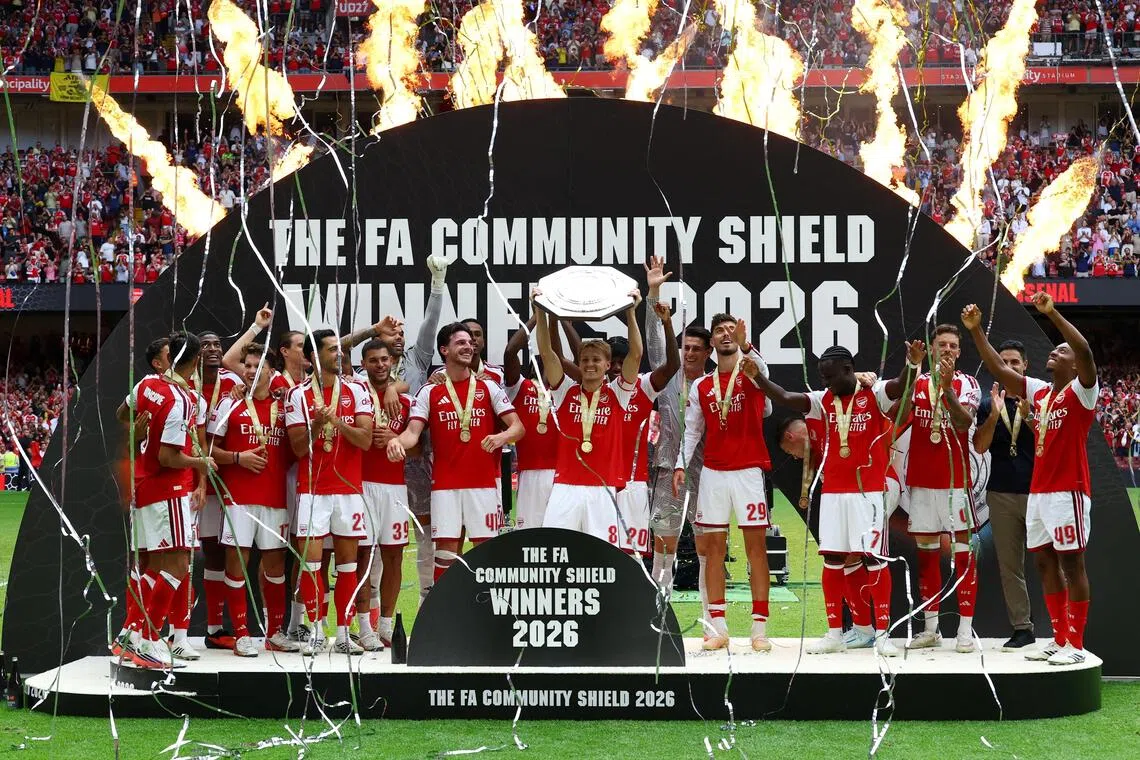 Arsenal’s Martin Odegaard lifting the trophy as the team celebrates winning the FA Community Shield on Aug 16.