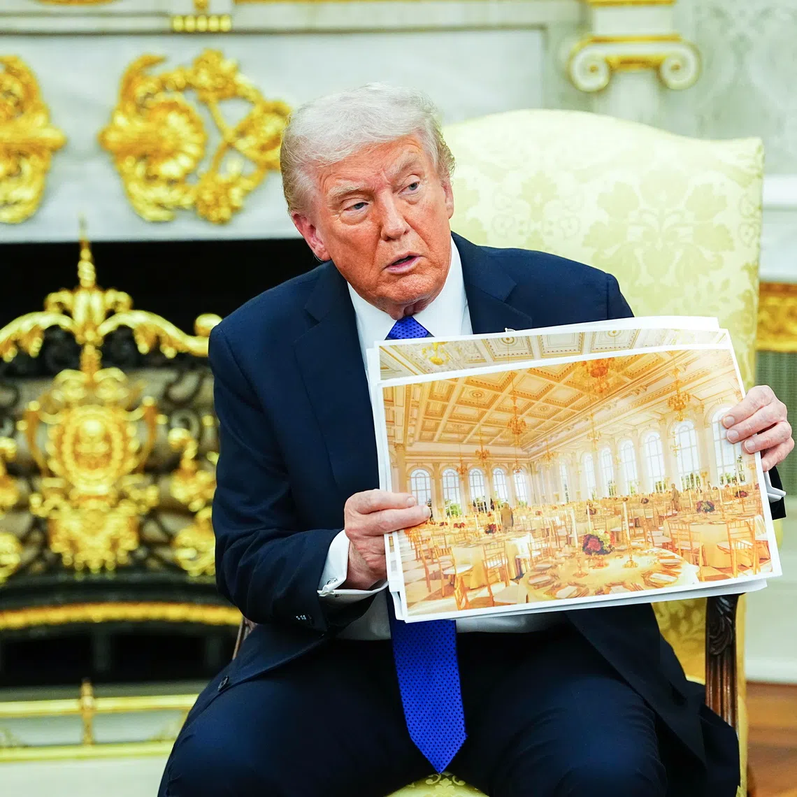 US President Donald Trump showing an interior rendering of the new White House Ballroom in the Oval Office of the White House on Oct 22.
