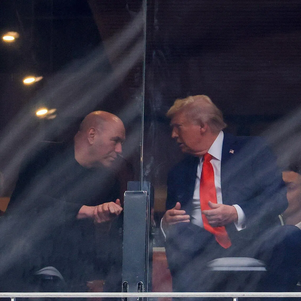 Ultimate Fighting Championship CEO Dana White (left) speaking with US President Donald Trump at the memorial service for political activist Charlie Kirk at State Farm Stadium on Sept 21, 2025 in Glendale, Arizona.