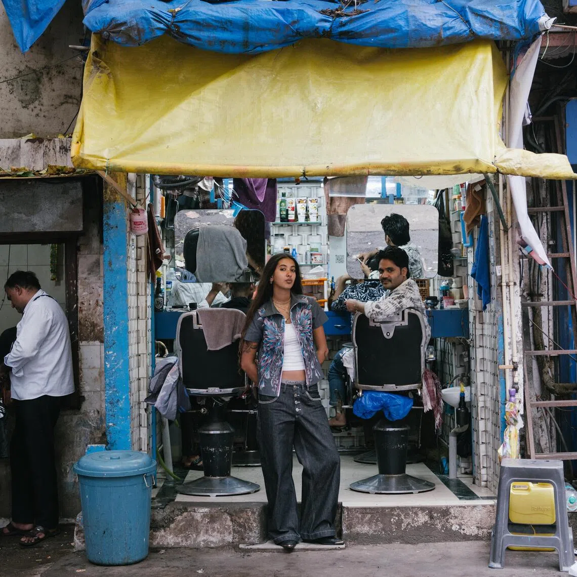 Diya Joukani in front of the barbershop near the workshop for her brand, DiyaDiya in the Bandra neighborhood of Mumbai, India, on July 7. Joukani’s popular videos on social media documenting her daily life in Mumbai have earned her a reputation as “the cool girl from India”. She has parlayed it into her brand.