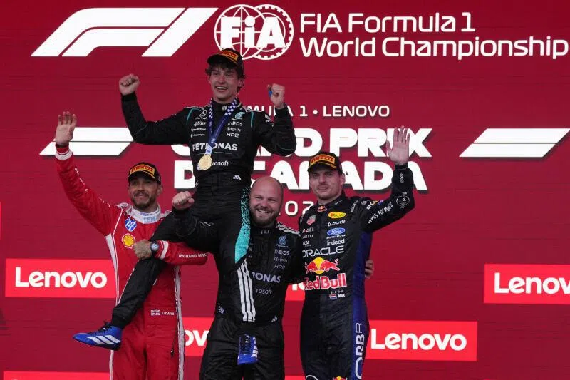 Mercedes' Andrea Kimi Antonelli celebrates on the podium after winning the Canadian Grand Prix alongside second placed Ferrari's Lewis Hamilton and third placed Red Bull's Max Verstappen.
