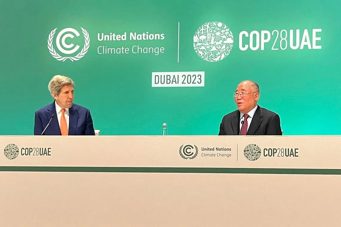 US climate envoy John Kerry (L) and his Chinese counterpart Xie Zhenhua give a joint news conference at the end of the COP28 climate summit in Dubai on December 13, 2023. The two veteran envoys, who have known each other for years, credited their cooperation with helping bring a successful outcome to the Dubai summit, which led to a call to transition away form fossil fuels. (Photo by Shaun TANDON / AFP)
