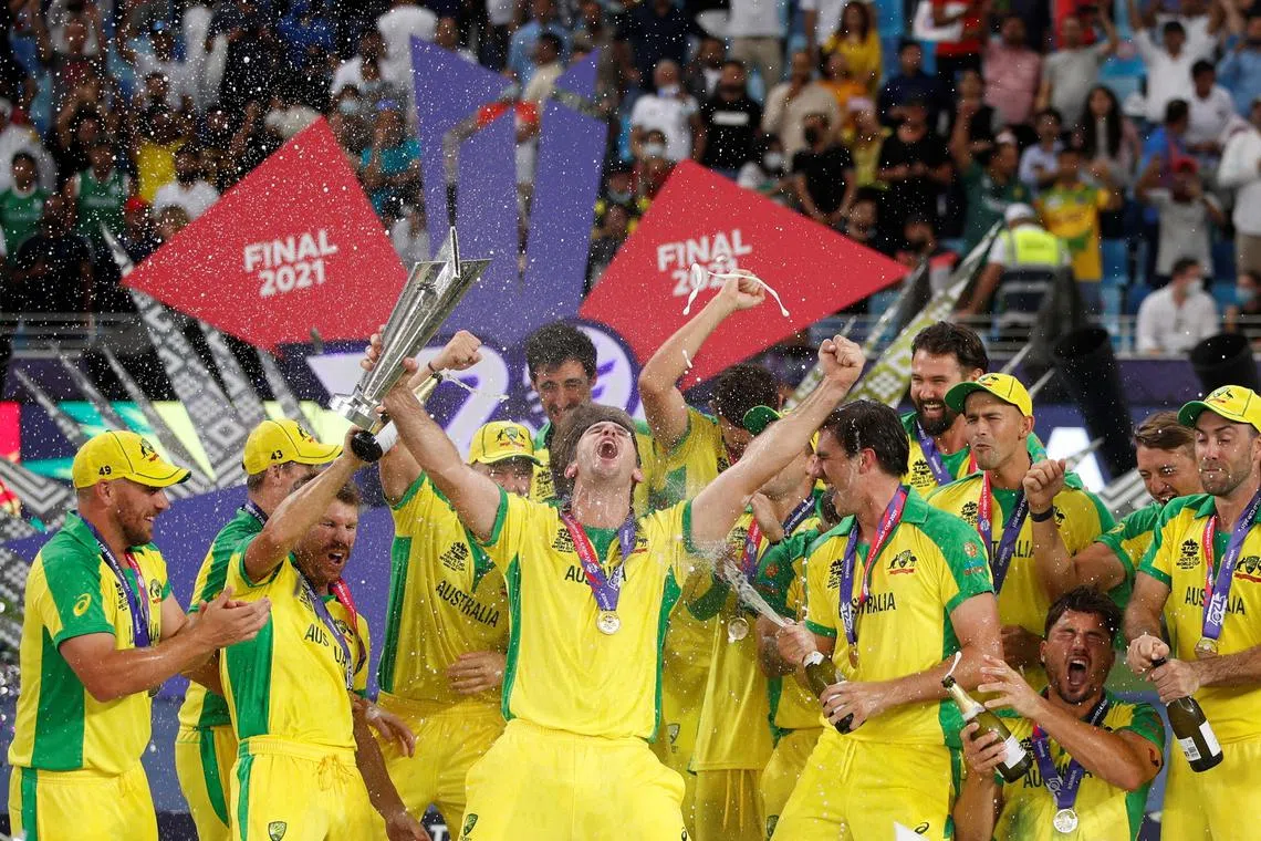 FILE PHOTO: Cricket - ICC Men's T20 World Cup Final - New Zealand v Australia- Dubai International Cricket Stadium, Dubai, United Arab Emirates - November 14, 2021 Australia's Mitchell Marsh celebrates with the trophy and teammates after winning the ICC Men's T20 World Cup REUTERS/Hamad I Mohammed/File Photo