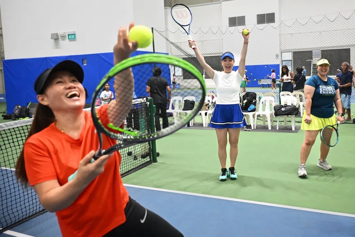 Latisha Chan, Taiwan’s former world No. 1 women’s doubles tennis player (centre) coaching Sani Fontanoz (left) and Retchel Ann Tipones (right) from the Philippines at the tennis clinic for domestic helpers on Sept 21.