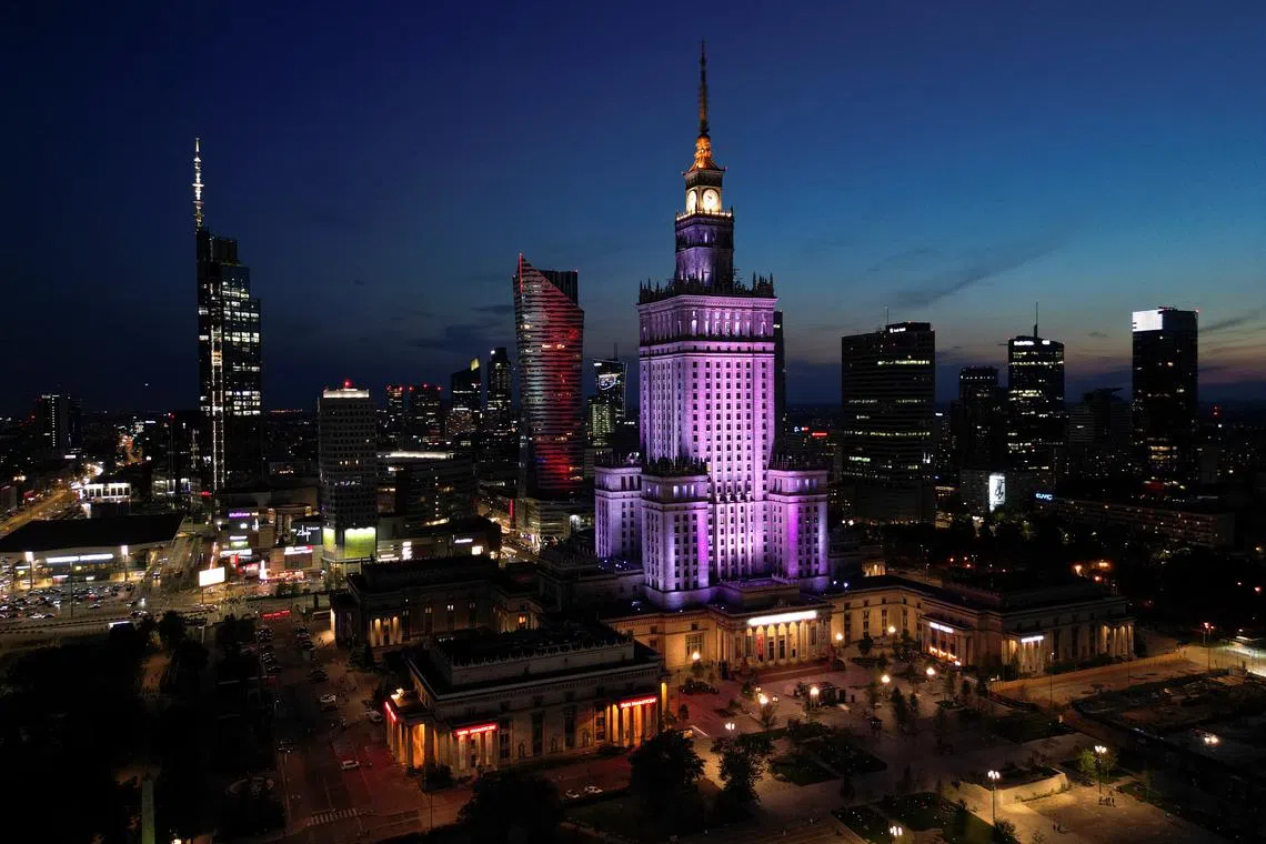 FILE PHOTO: A drone view shows Warsaw’s skyline at night, with illuminated skyscrapers and the Palace of Culture and Science in Warsaw, Poland, July 21, 2025. REUTERS/Kuba Stezycki/File Photo