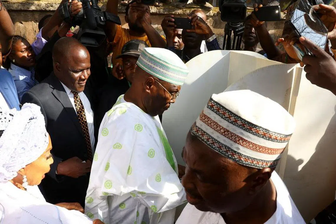 Atiku Abubakar of the People's Democratic Party, the main opposition candidate in Nigeria's presidential election, stands at a voting booth before casting a ballot at a polling station in Yola, Nigeria, February 25, 2023. REUTERS/Esa Alexander