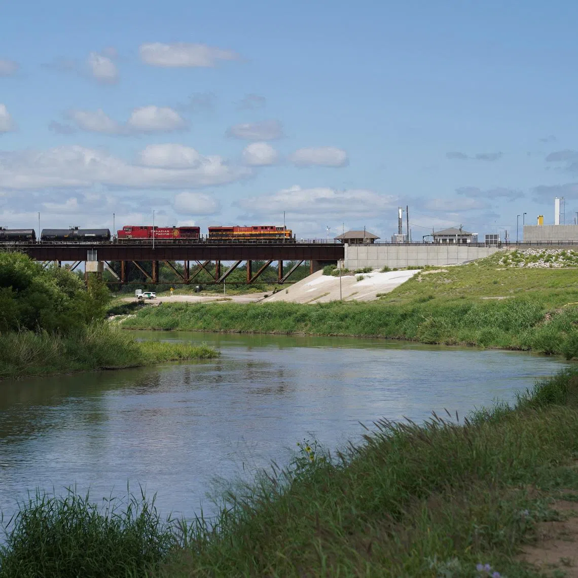 A freight train coming from Mexico crosses the border after six bodies were found on Sunday in a train boxcar, in Laredo, Texas, U.S. May 11, 2026.  REUTERS/Gabriel V. Cardenas