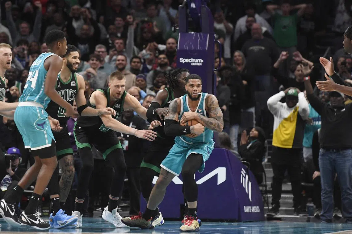 Charlotte Hornets forward Miles Bridges gets a rebound from a missed foul shot in the closing seconds of overtime against the Boston Celtics at the Spectrum Centre.