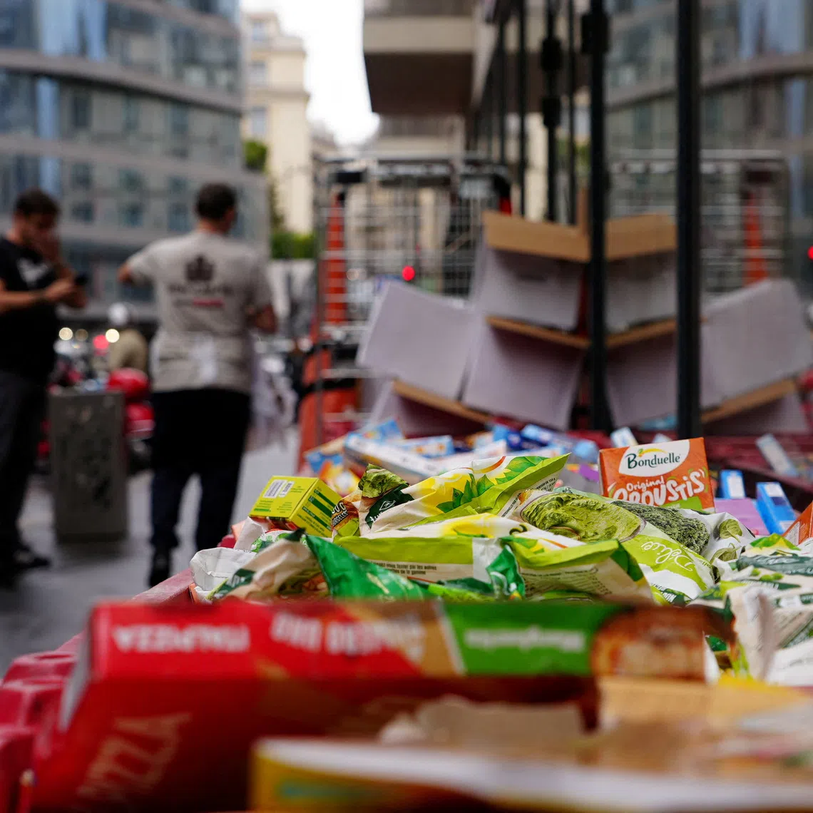 Boxes of perished goods are discarded outside an Intermarche supermarket in Paris on Oct 13, the day after a cyberattack targeted refrigeration systems at French chains, causing food losses and fires at several stores.