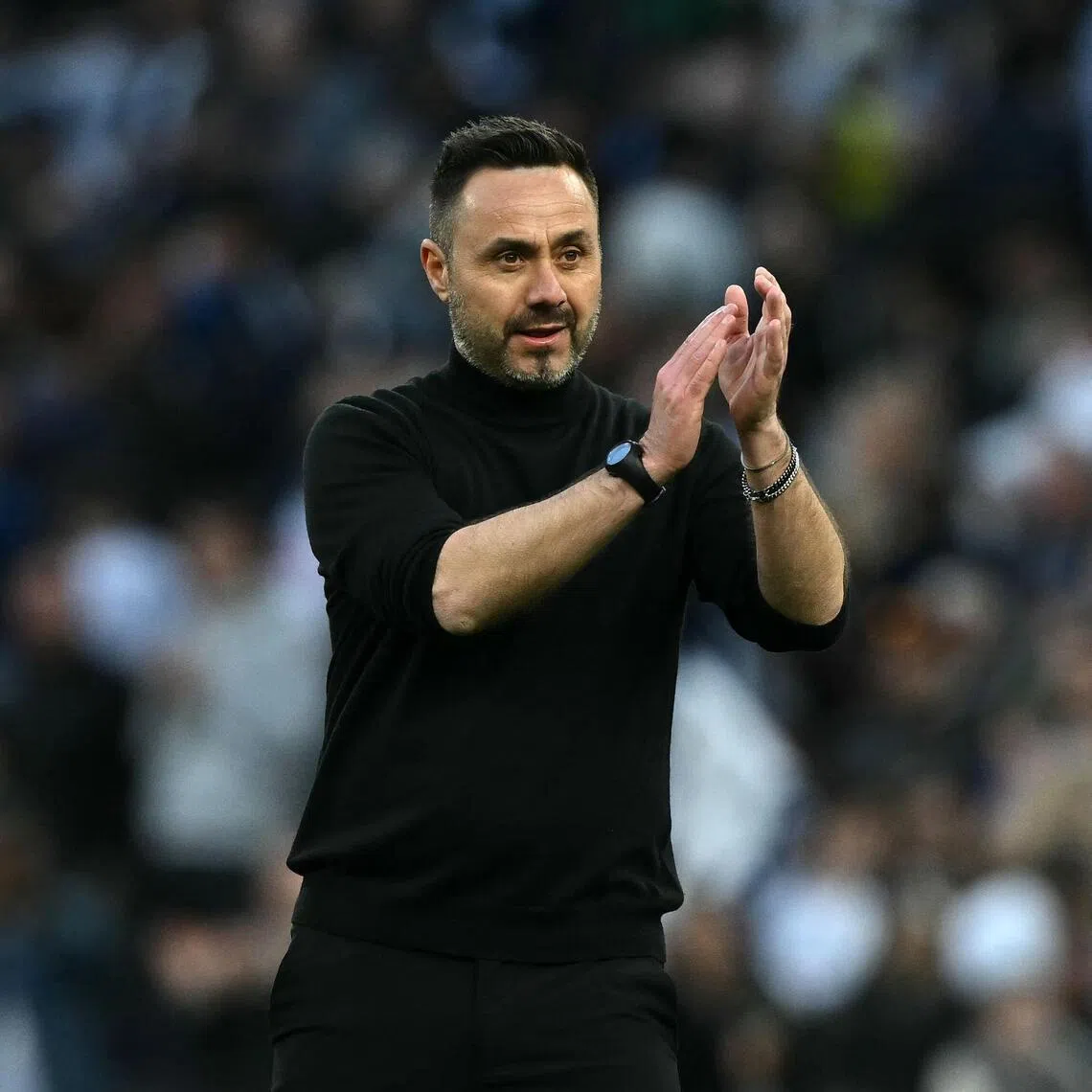 Tottenham Hotspur manager Roberto De Zerbi applauds fans on the pitch after the 2-2 Premier League draw with his former club Brighton & Hove Albion.