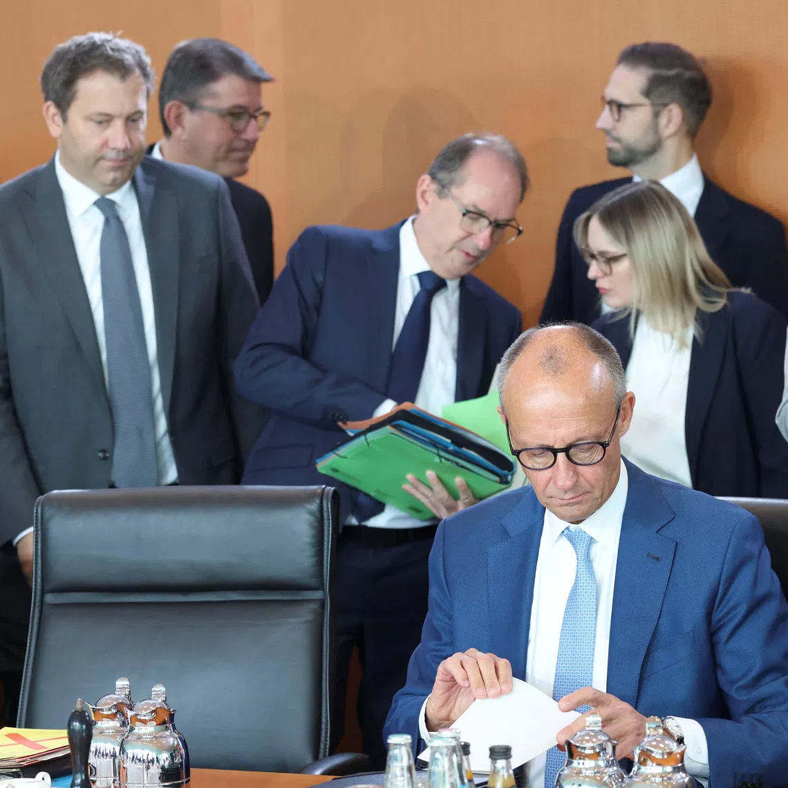 German Chancellor Friedrich Merz waits for a cabinet meeting next to Interior Minister Alexander Dobrindt and Finance Minister Lars Klingbeil at the Chancellery in Berlin, Germany, October 7, 2026. REUTERS/Leonhard Foeger