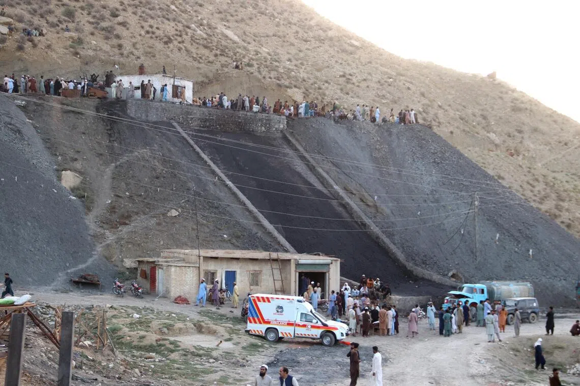 Rescue workers and locals gather at a coal mine after a blast on the outskirts of Quetta, Pakistan, on July 30.