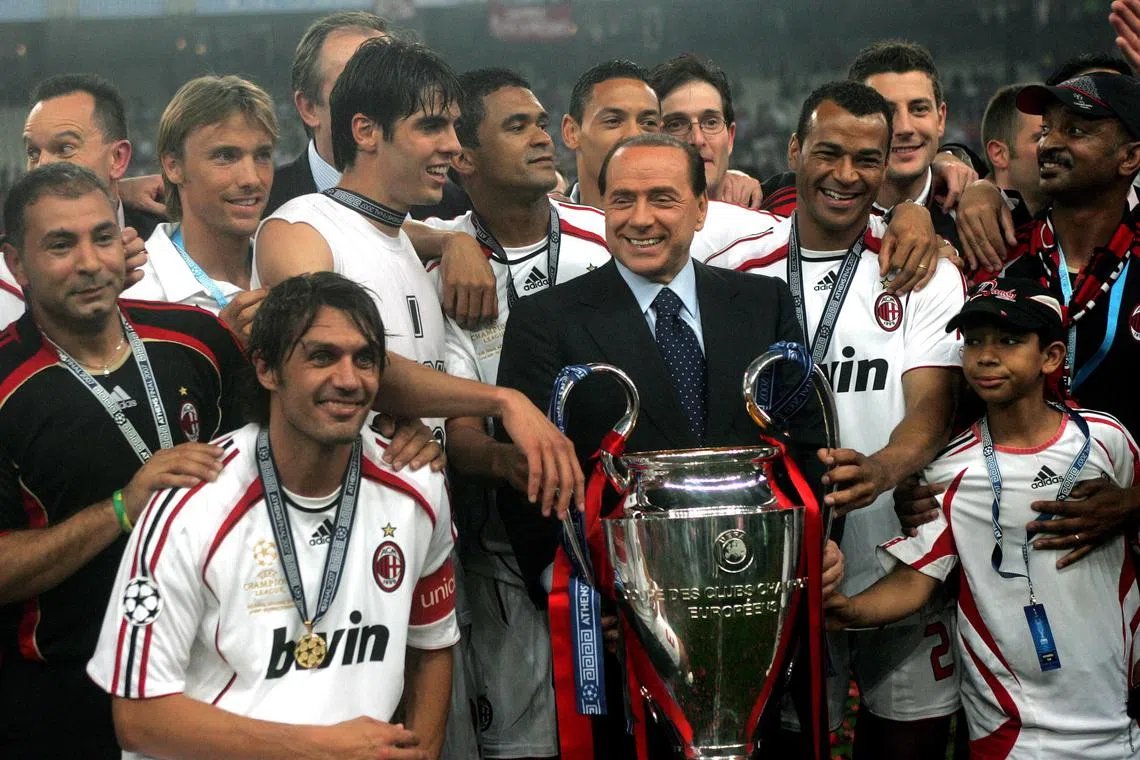 Mr Silvio Berlusconi celebrates with AC Milan players after the club won the UEFA Champions League in Greece in 2007.