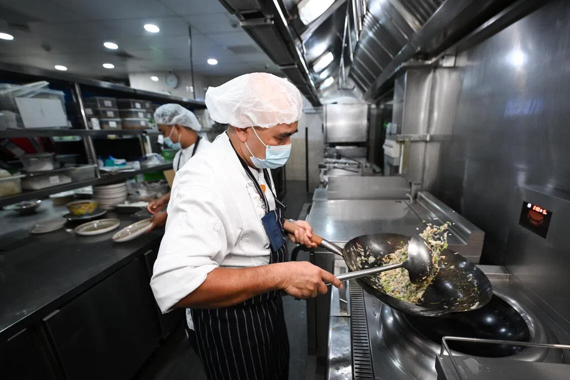 Parkway East Hospital’s executive chef Roslan Abbas cooking Baba Nonya Fried Rice.