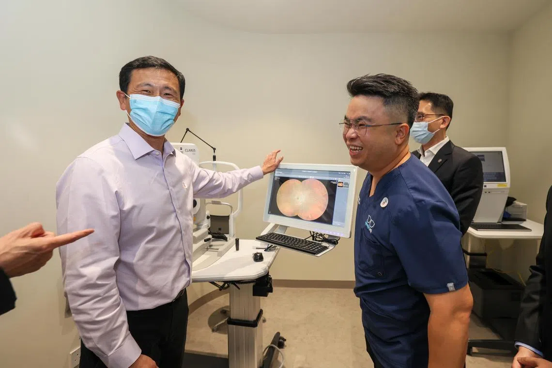 Health Minister Ong Ye Kung at the eye screening clinic learning about glaucoma while touring the Fullerton Health Screening Centre at Novena.