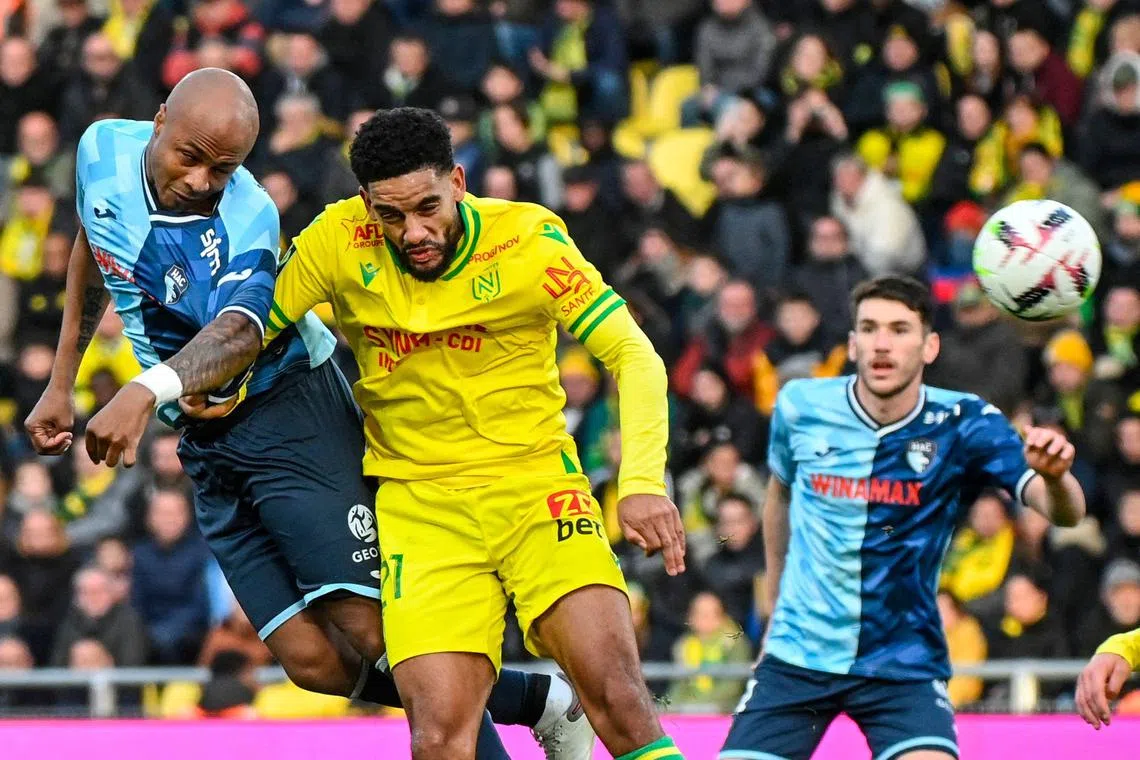 Le Havre's Ghanaian attacker Andre Ayew heading the ball past Nantes' Cameroonian defender Jean-Charles Castelletto during a French Ligue 1 match. The 34-year old is now setting his sights on breaking a couple of records at the Africa Cup of Nations.