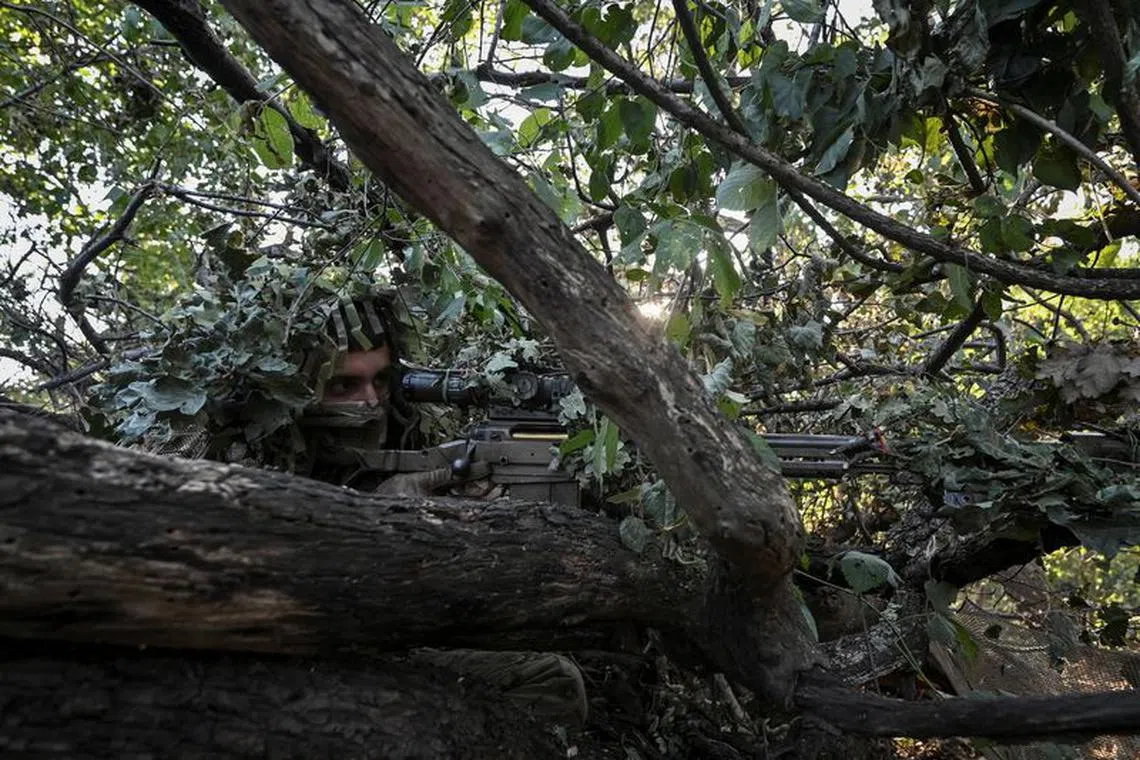 FILE PHOTO: A sniper of Ukraine's 3rd Separate Assault Brigade takes a position during a reconnaissance mission, amid Russia's attack on Ukraine, near Bakhmut, Ukraine September 7, 2023. REUTERS/Stringer/File Photo