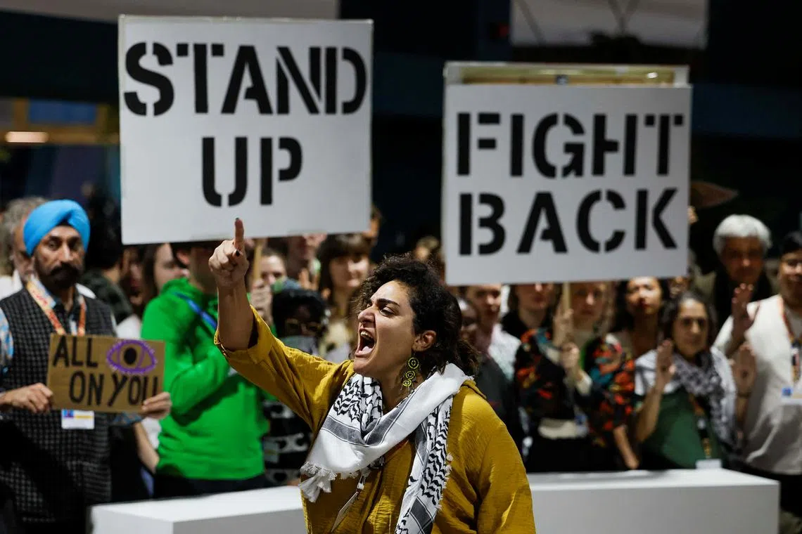 Activists shout slogans during a protest action at the COP29 United Nations climate change conference, in Baku, Azerbaijan November 23, 2024. REUTERS/Maxim Shemetov