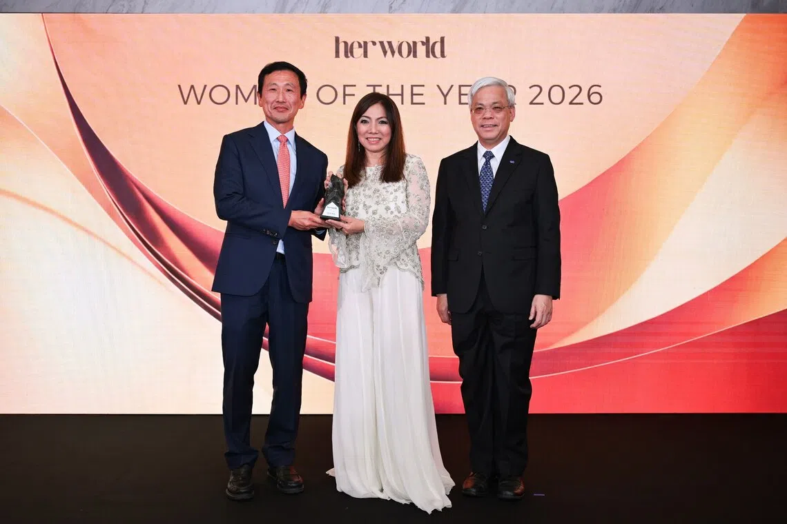 Ms Tan Su Shan (centre) receiving her award from Minister for Health and Coordinating Minister for Social Policies Ong Ye Kung (left) and SPH Media’s executive chairman Chan Yeng Kit during the annual Her World Women of the Year 2026 Awards at METT Singapore on Oct 6.