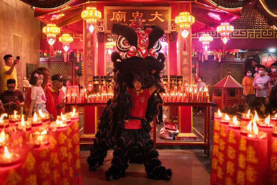A man performing a lion dance at a temple in Jakarta on Feb 10, 2024, the first day of the Lunar New Year of the Dragon. 