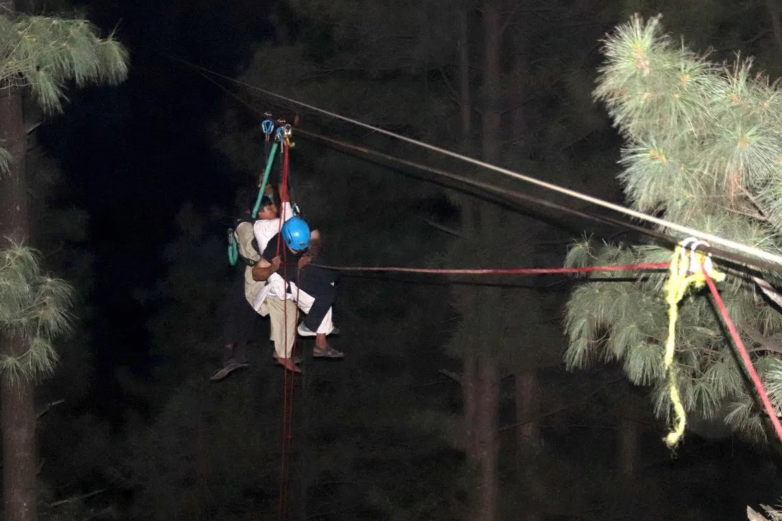 Pakistani army soldiers carry out rescue operation for stranded in a chairlift students in Battagram district, Pakistan.