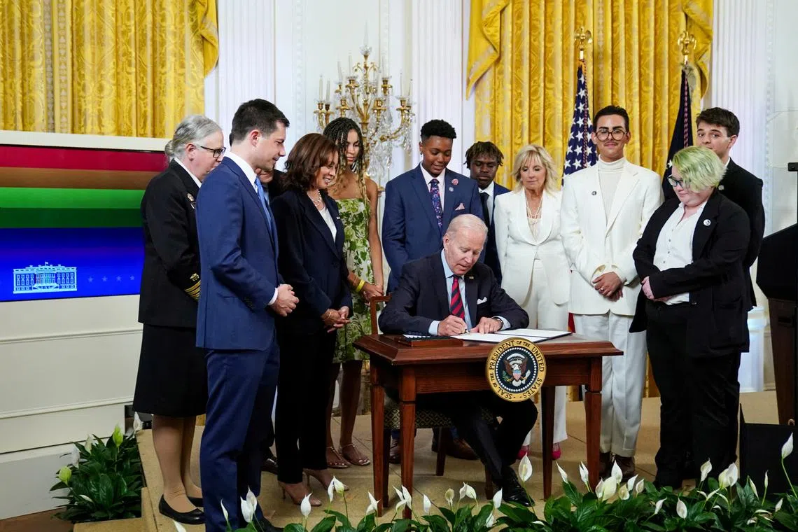 FILE PHOTO: U.S. President Joe Biden signs an executive order that aims to advance equality for LGBTQI+ individuals during a Pride Month event in the East Room of the White House in Washington, U.S., June 15, 2022. REUTERS/Sarah Silbiger/File Photo
