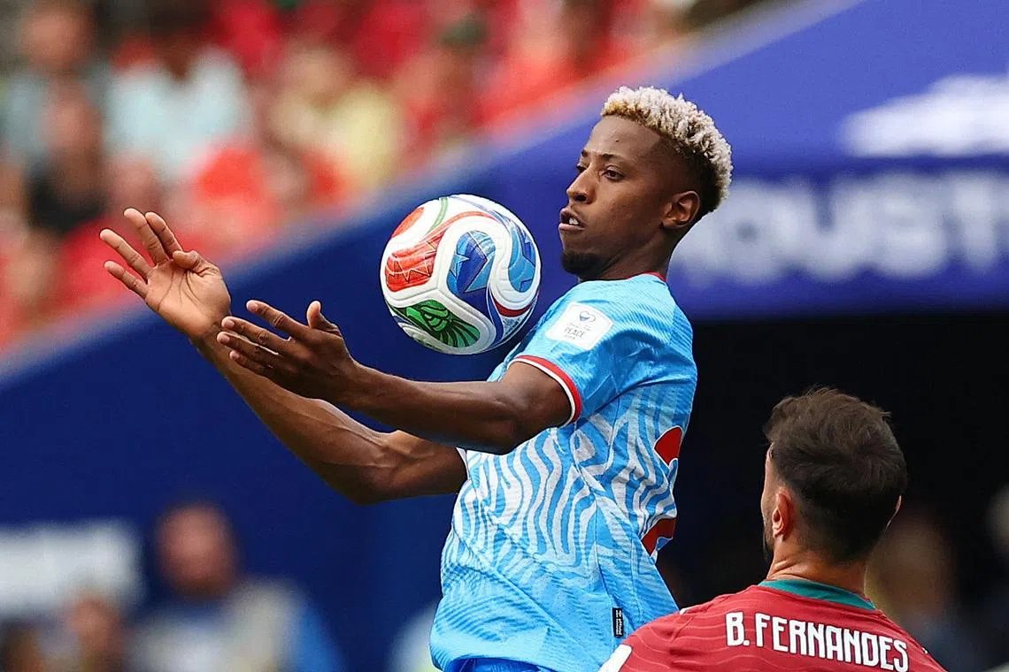 Soccer Football - FIFA World Cup 2026 - Group K - Portugal v DR Congo - Houston Stadium, Houston, Texas, U.S. - June 17, 2026 DR Congo's Simon Banza in action with Portugal's Bruno Fernandes REUTERS/Pedro Nunes