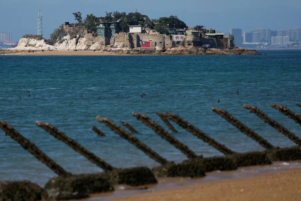 FILE PHOTO: Shiyu or Lion Islet, which is part of Kinmen County, one of Taiwan's offshore islands, is pictured with China's Xiamen in the background, in Kinmen, Taiwan February 21, 2024. REUTERS/Ann Wang/File Photo