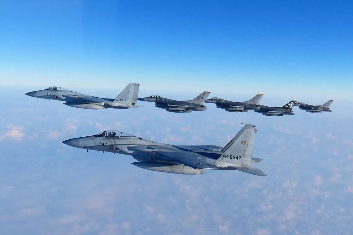 Japan's Air Self-Defense Force F-15 fighters and US Air Force F-16 fighters flying during a joint exercise on Feb 19.