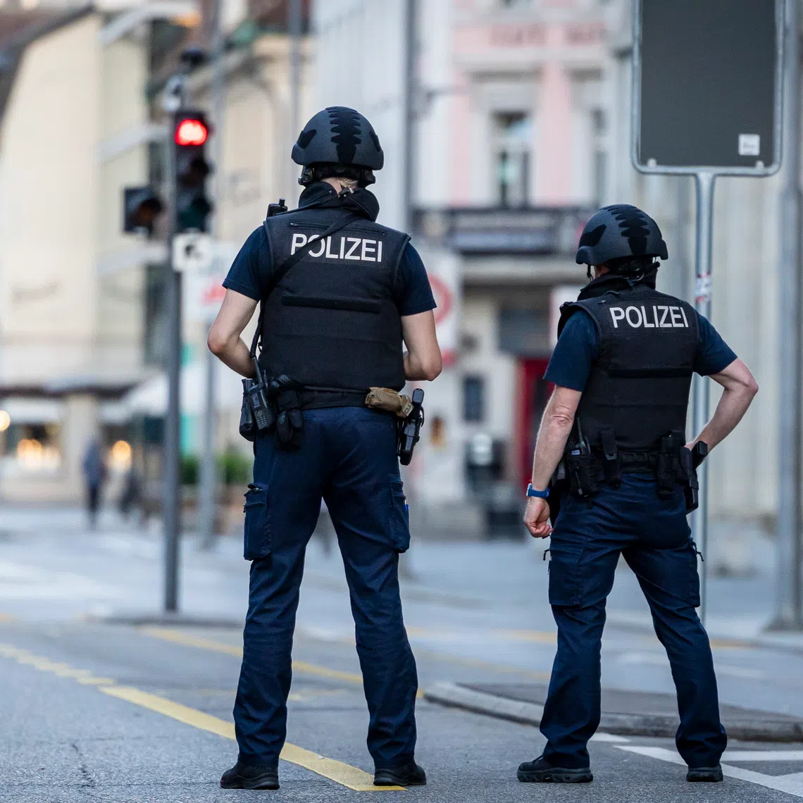 Swiss police officers patrol a street in downtown Aarau after reports of a shooting on Aug 30.
