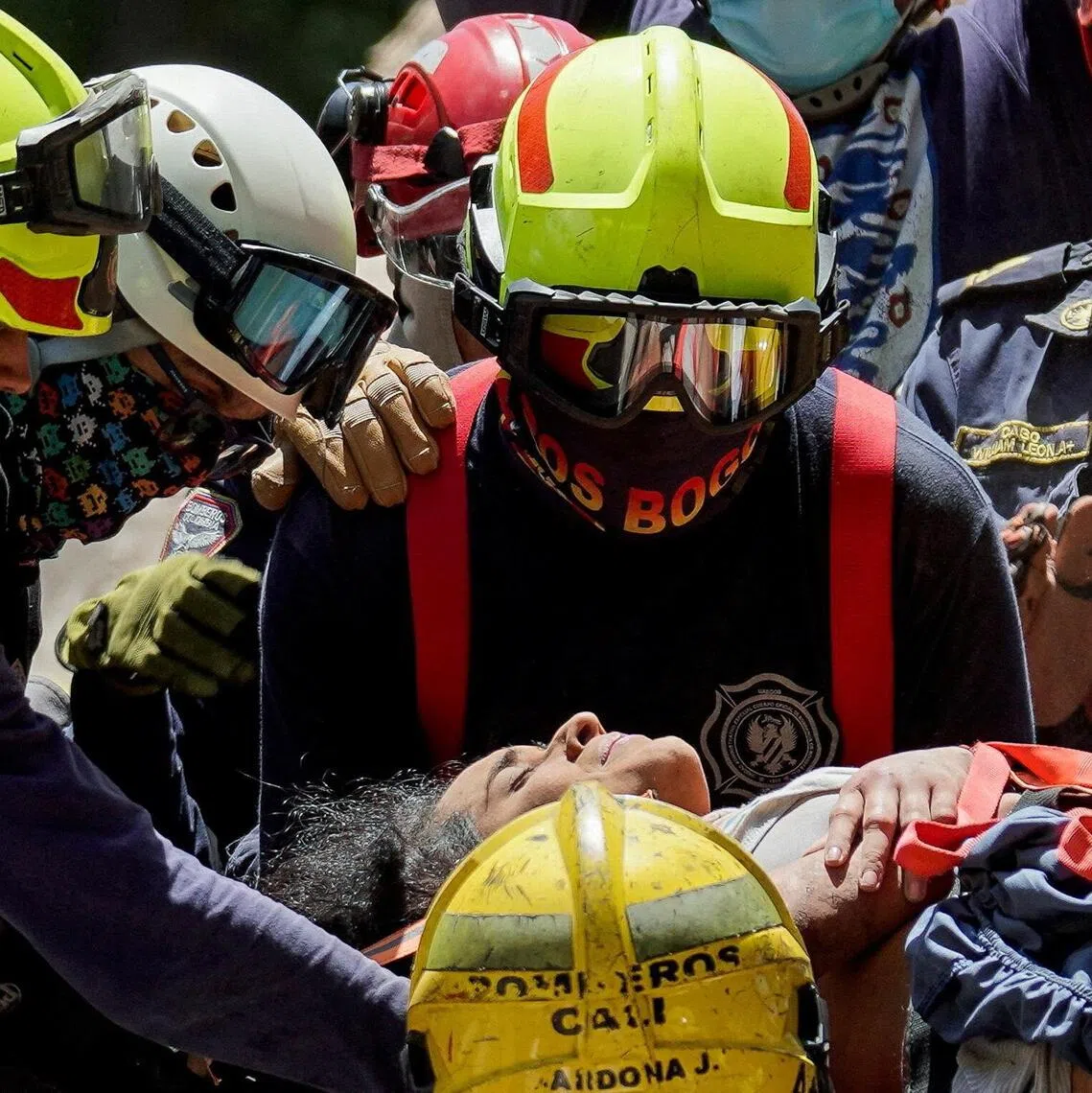 Rescuers carrying earthquake survivor Diana Troncoso from the debris of a collapsed building in Cali, Colombia, on Aug 11.