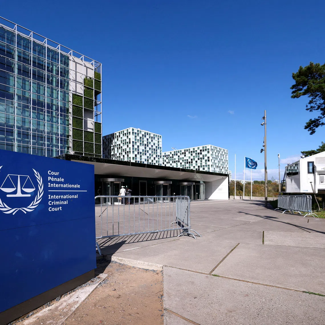 FILE PHOTO: People stand outside the International Criminal Court in the Hague, Netherlands, September 22, 2025. REUTERS/Piroschka van de Wouw/File Photo